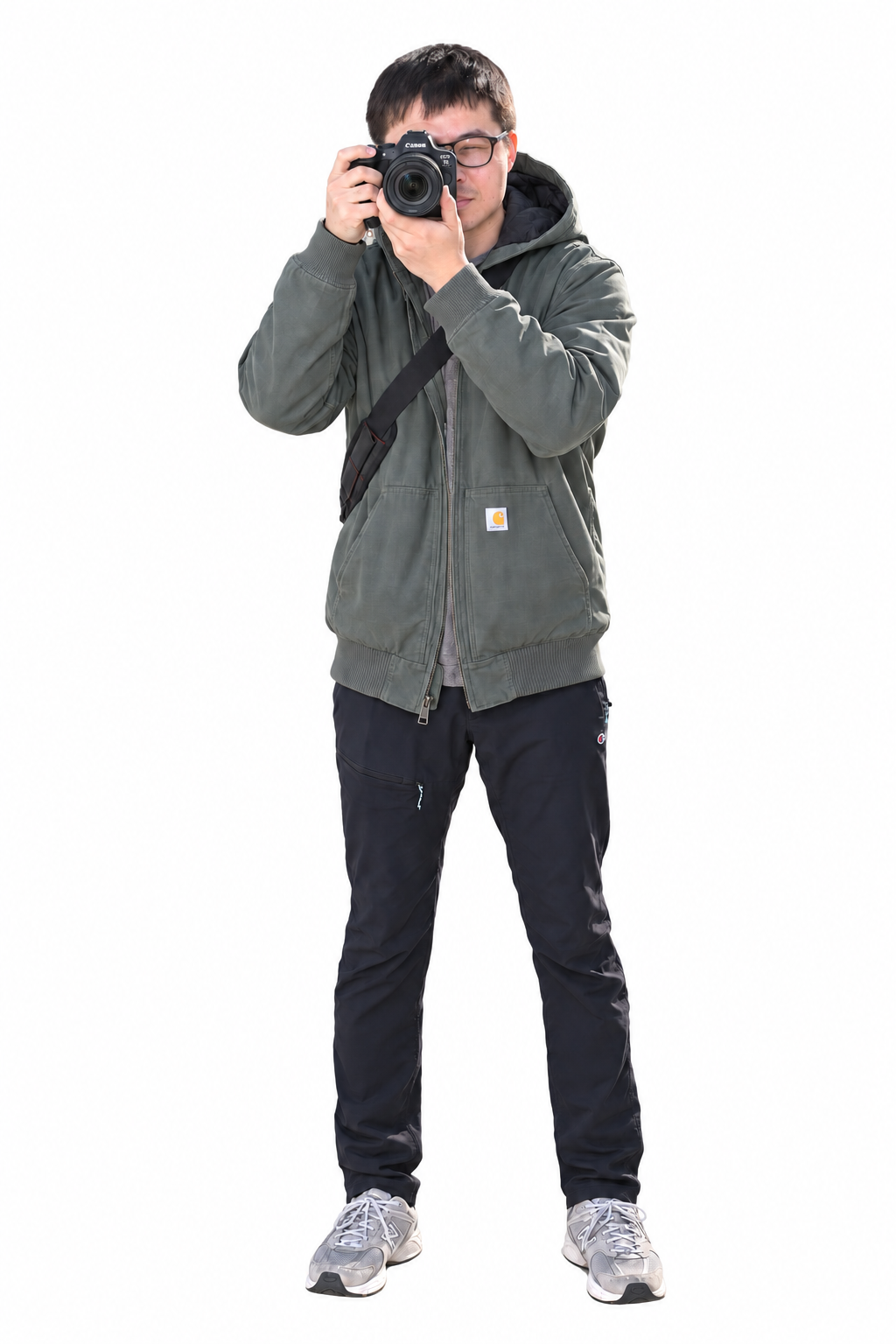 Adam You, standing and holding a Canon camera up to take a photograph