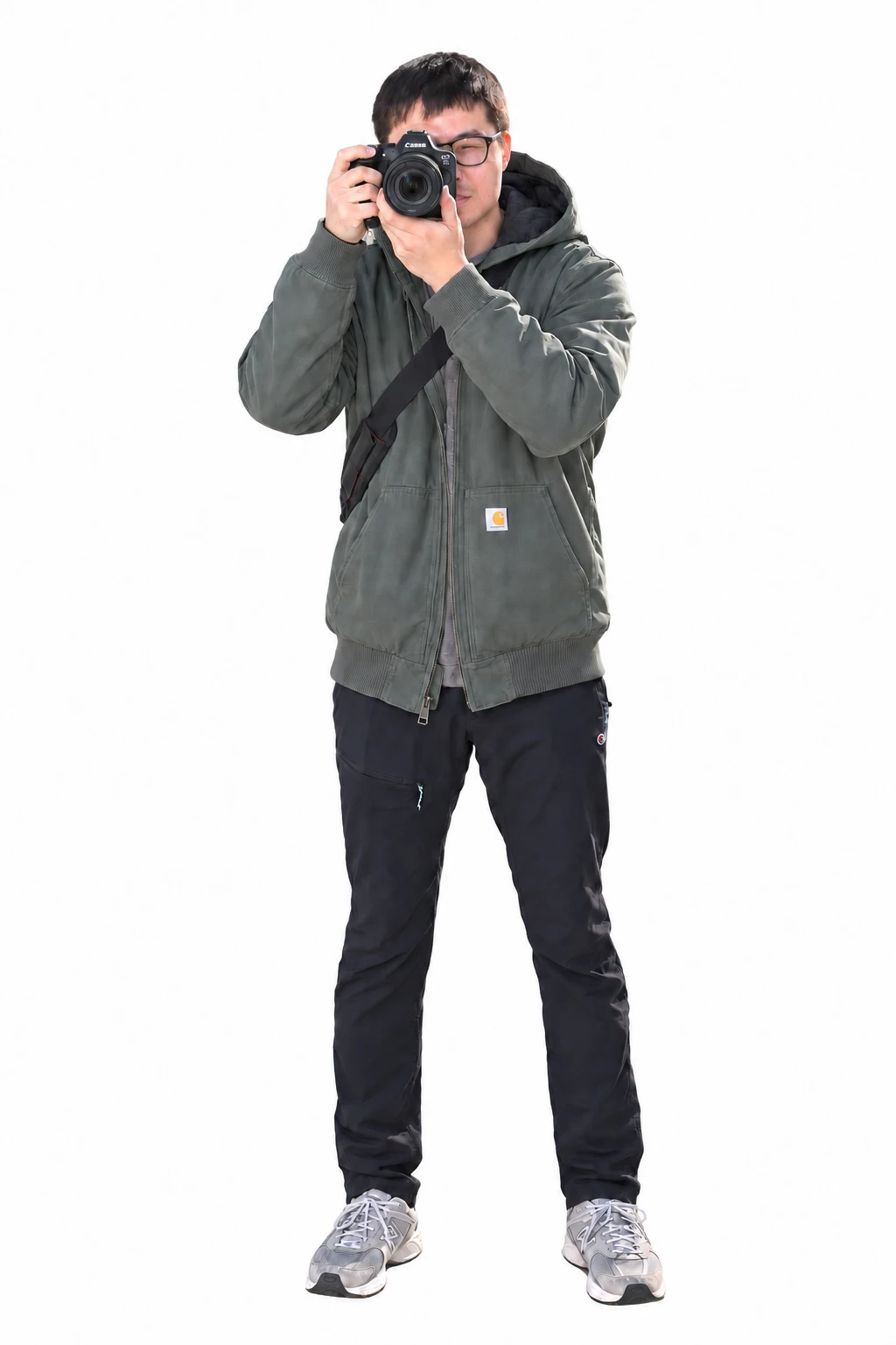Adam You, standing and holding a Canon camera up to take a photograph